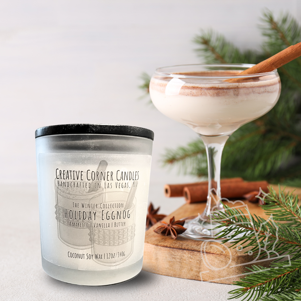 Candle labeled 'Holiday Eggnog' next to a eggnog cocktail with cinnamon sticks and greenery on a light background