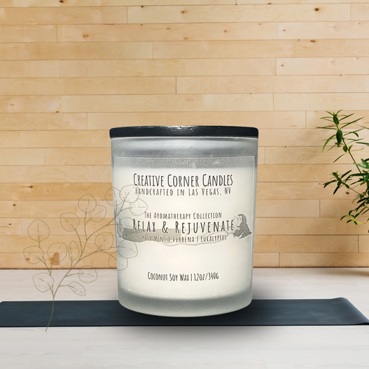 Relax and Rejuvenate handcrafted candles with a refreshing scent and a label illustrated with a hand-drawn depiction of a woman lying in a restful position
