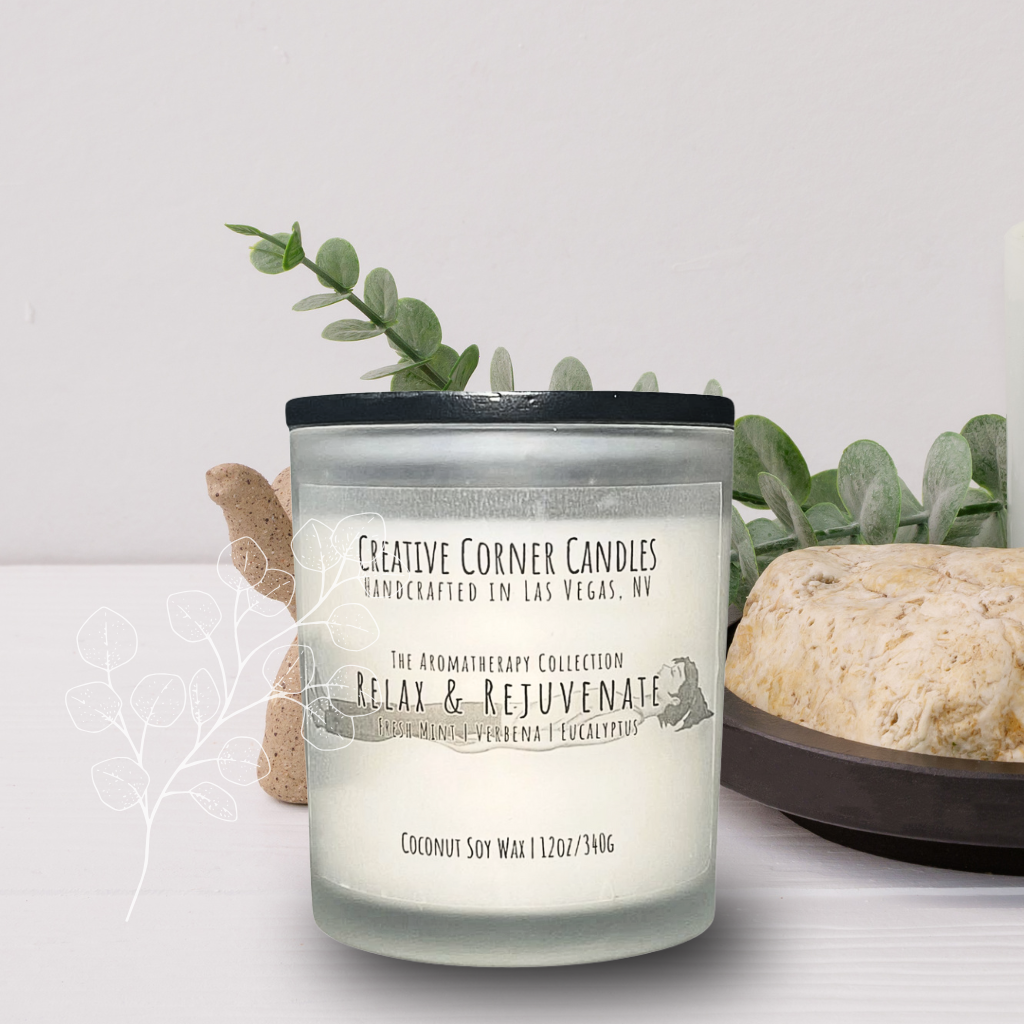 Relax and Rejuvenate handcrafted candles with a refreshing scent and a label illustrated with a hand-drawn depiction of a woman lying in a restful position