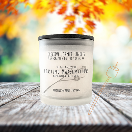Roasting Marshmallows fall candle with marshmallow, oak, and smoky scent in coconut soy wax, hand-drawn label illustration of a stick with two marshmallows roasting.