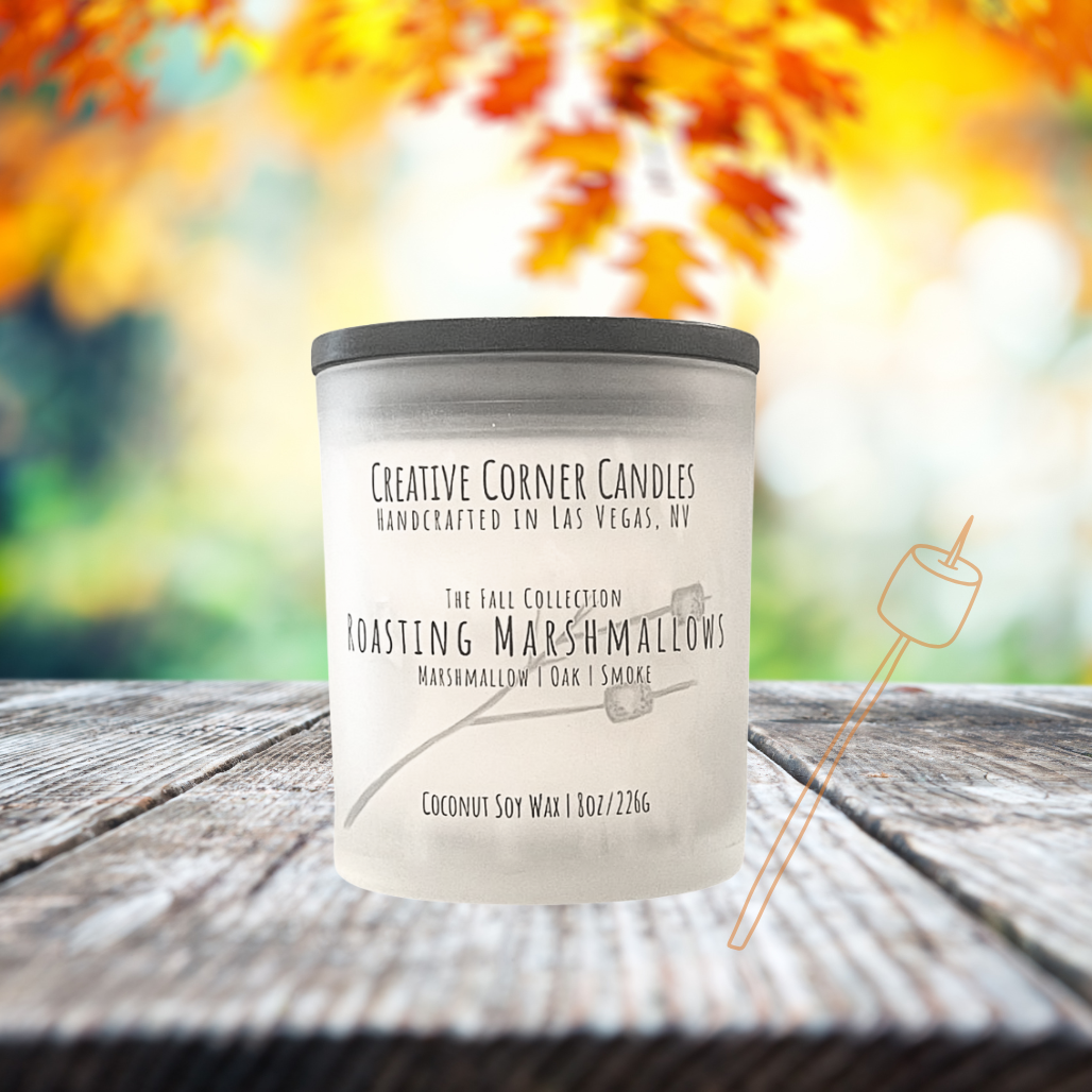Roasting Marshmallows fall candle with marshmallow, oak, and smoky scent in coconut soy wax, hand-drawn label illustration of a stick with two marshmallows roasting.