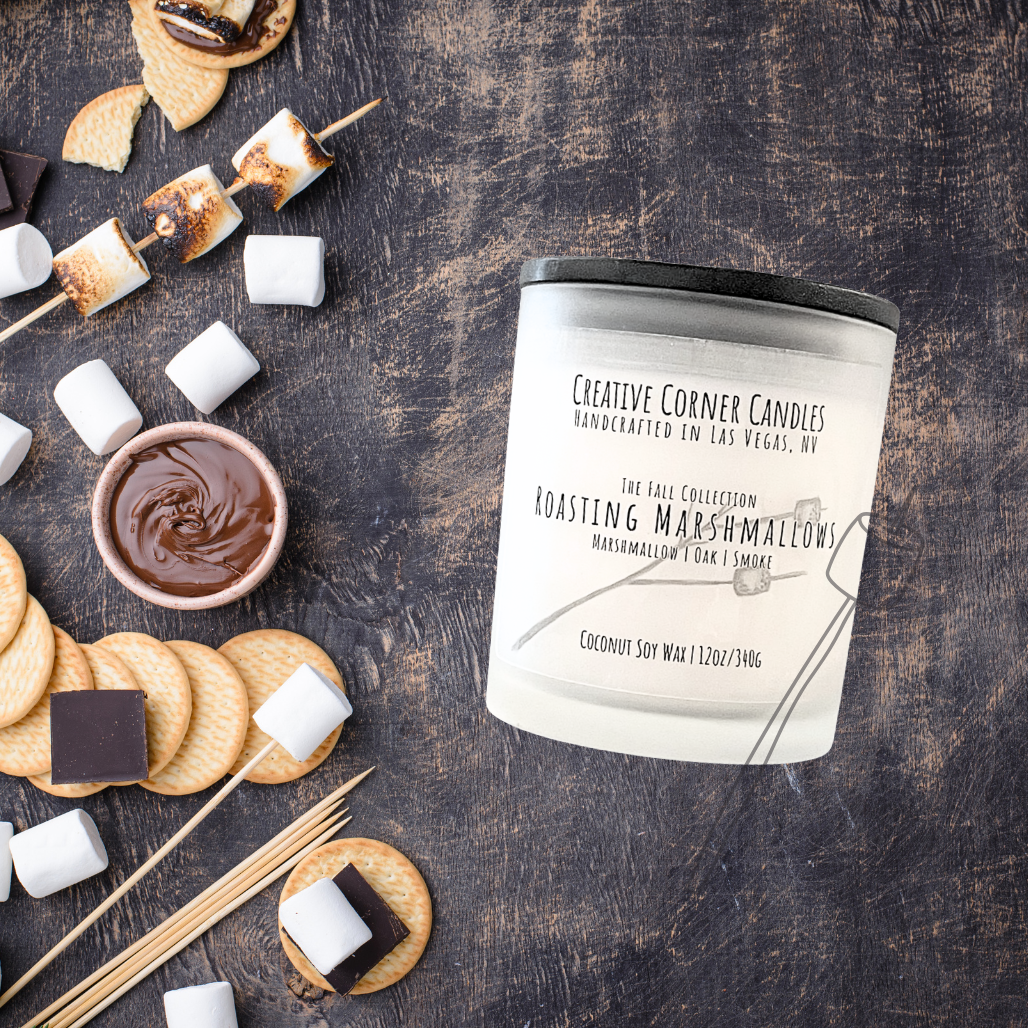 Roasting Marshmallows fall candle with marshmallow, oak, and smoky scent in coconut soy wax, hand-drawn label illustration of a stick with two marshmallows roasting.