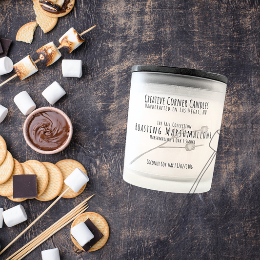 Roasting Marshmallows fall candle with marshmallow, oak, and smoky scent in coconut soy wax, hand-drawn label illustration of a stick with two marshmallows roasting.