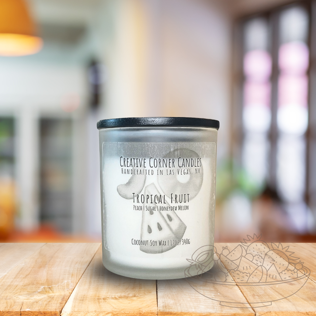 Tropical Fruit handcrafted candles with a vibrant, fruity scent and a label showcasing a hand-drawn illustration of tropical fruits.