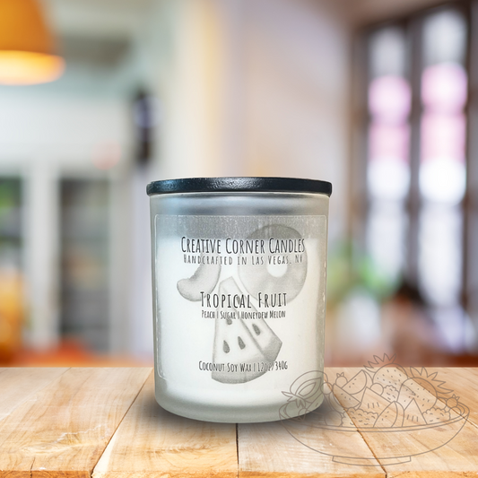 Tropical Fruit handcrafted candles with a vibrant, fruity scent and a label showcasing a hand-drawn illustration of tropical fruits.