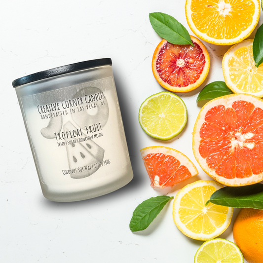 Tropical Fruit handcrafted candles with a vibrant, fruity scent and a label showcasing a hand-drawn illustration of tropical fruits.