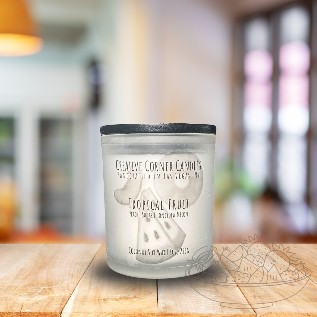 Tropical Fruit handcrafted candles with a vibrant, fruity scent and a label showcasing a hand-drawn illustration of tropical fruits.