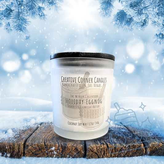 Candle labeled 'Holiday Eggnog' from Creative Corner Candles on a snowy background with Christmas decorations.