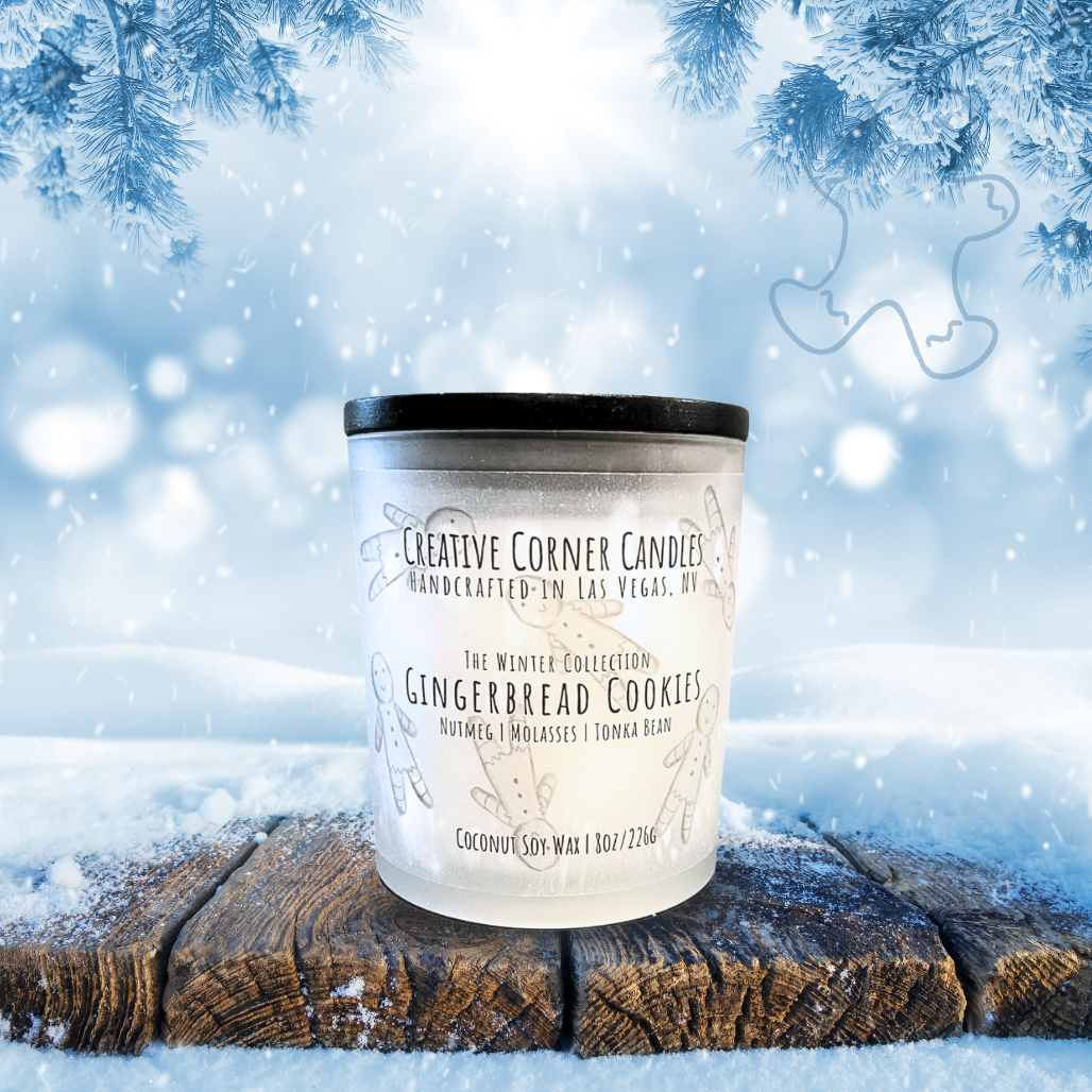 Frosted candle with a black lid on a wooden log against a snowy background