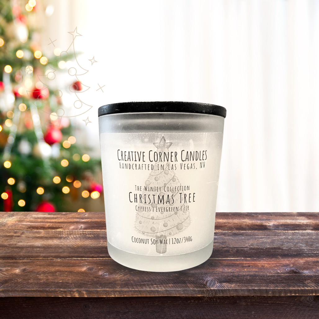 Candle with a label on a wooden surface with a blurred Christmas tree in the background
