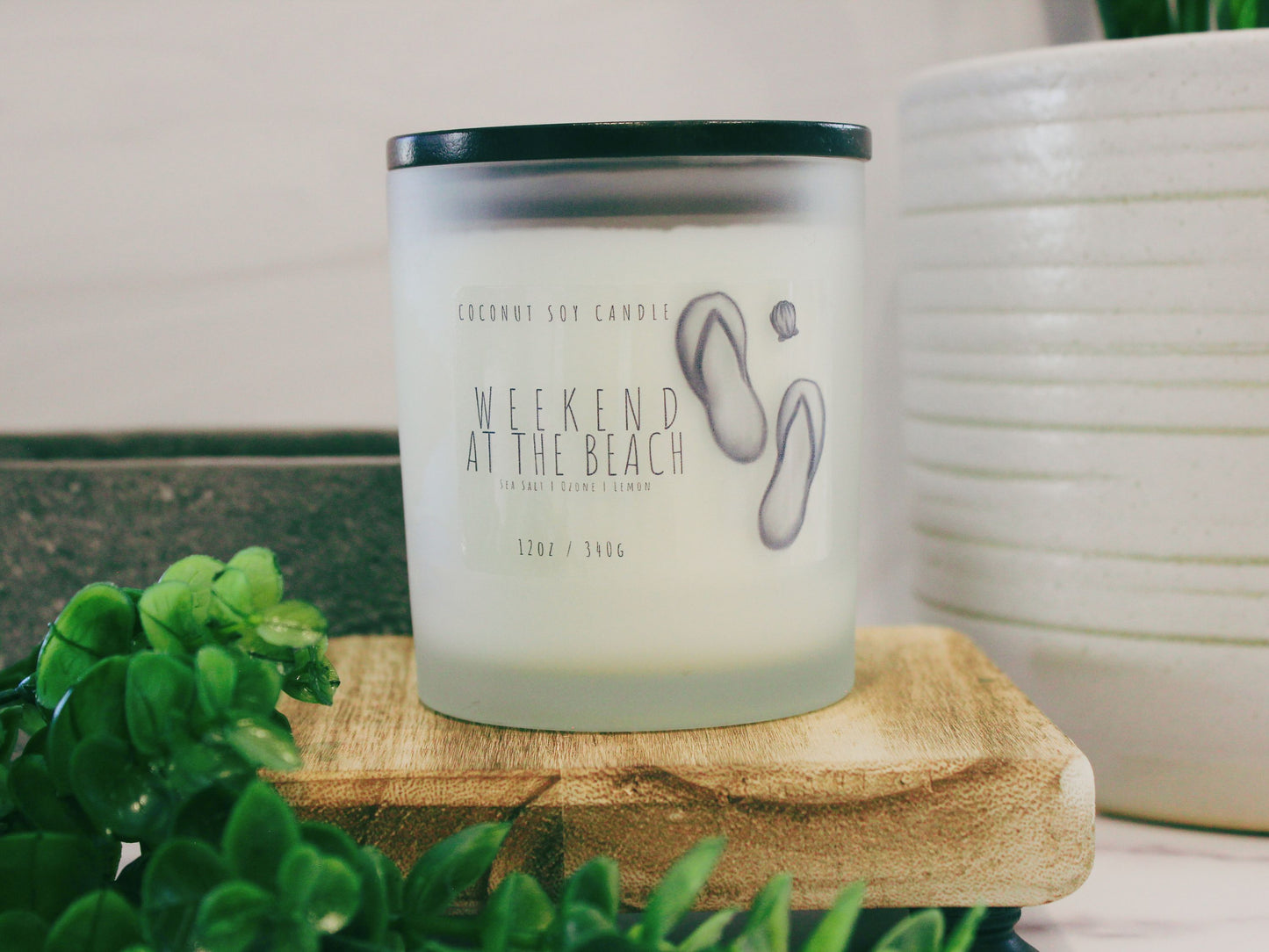 Transport your senses to the coast with 'Weekend at the Beach,' a Coconut Soy Candle. Housed in an elegant glass jar, this hand-poured candle emits a warm, beachy glow. The label features a beach-inspired design, capturing the essence of a relaxing seaside getaway. Enjoy the harmonious blend of coconut and soy wax for a clean, enduring burn. Elevate your space with the refreshing scents of 'Weekend at the Beach' candle. Ideal for creating a coastal ambiance at home. Shop now for a beach retreat experience.