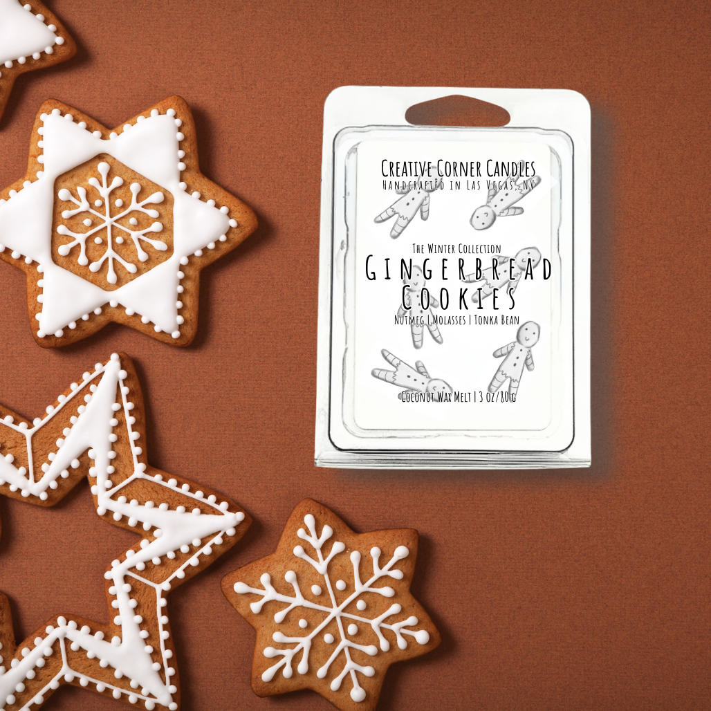 Decorative gingerbread cookies with white icing next to a wax melt label "Gingerbread Cookies" on a brown background