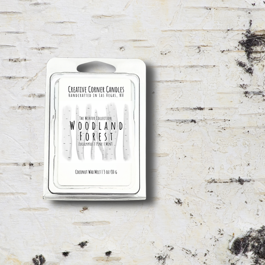 Wax melt packaging labeled 'Woodland Forest' by Creative Corner Candles on a textured white background.