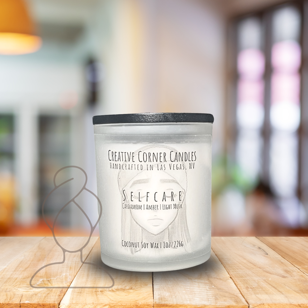 Selfcare handcrafted candles with a gentle, rejuvenating scent and a label featuring a hand-drawn illustration of a woman's face with closed eyes and a spa headband.