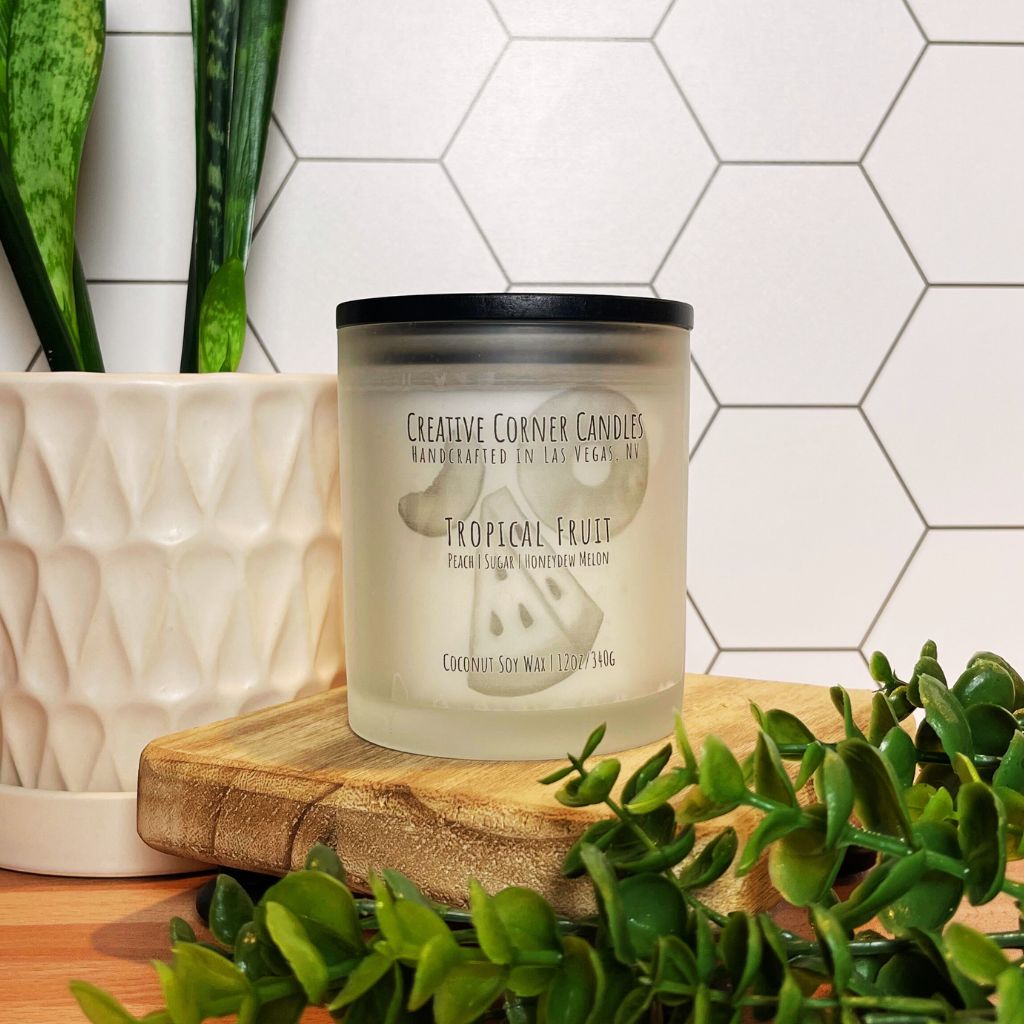 Tropical Fruit handcrafted candles with a vibrant, fruity scent and a label showcasing a hand-drawn illustration of tropical fruits