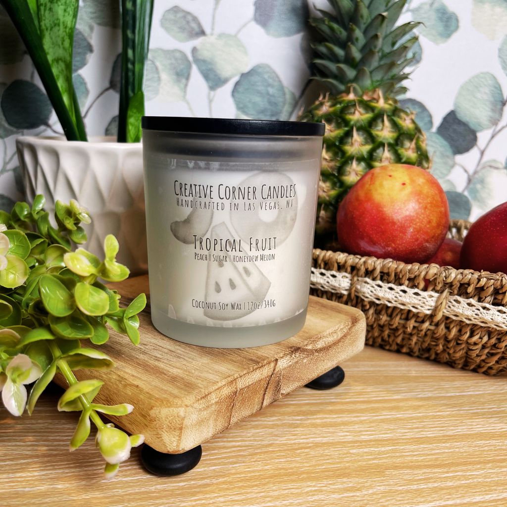 Tropical Fruit handcrafted candles with a vibrant, fruity scent and a label showcasing a hand-drawn illustration of tropical fruits